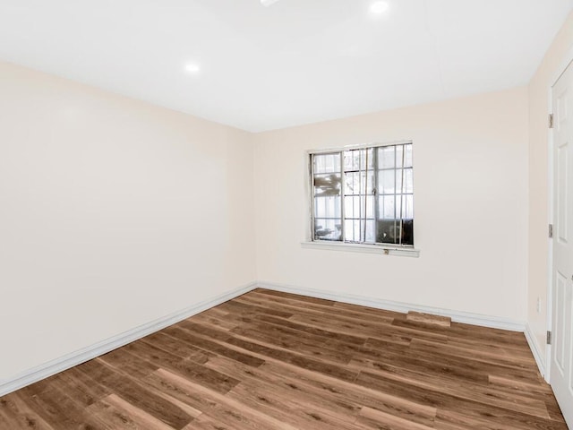 spare room with dark wood-type flooring