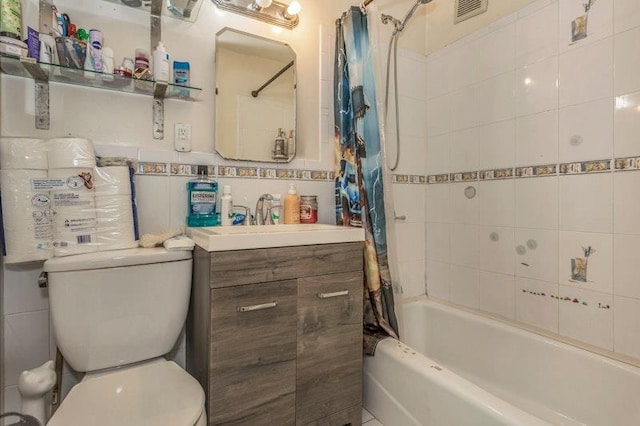 full bathroom with tile walls, vanity, shower / bath combo, and toilet