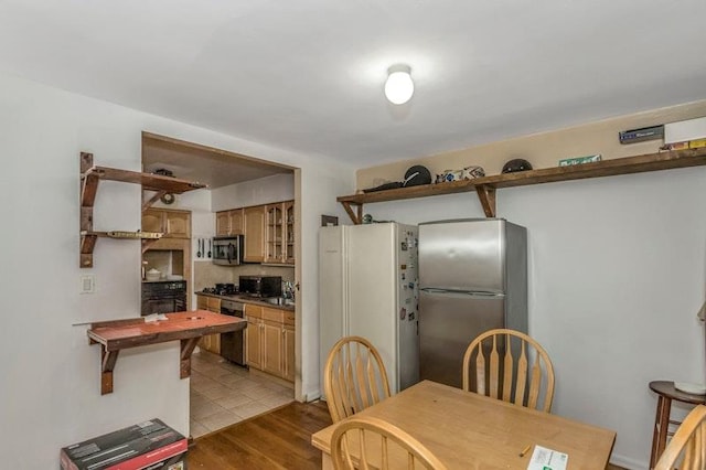 dining space with light hardwood / wood-style floors