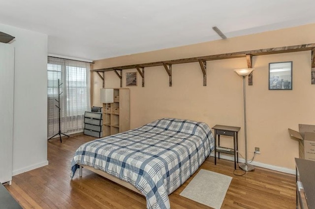 bedroom with hardwood / wood-style flooring