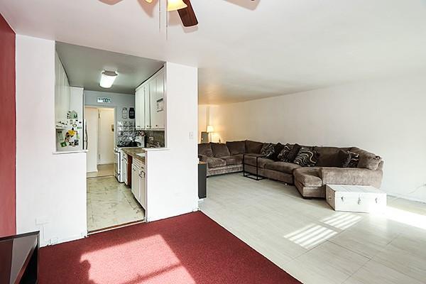 living room with light colored carpet and ceiling fan