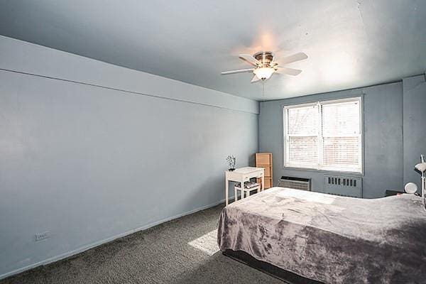 carpeted bedroom featuring radiator heating unit and ceiling fan