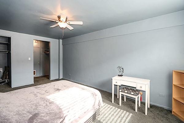 carpeted bedroom featuring ceiling fan and two closets