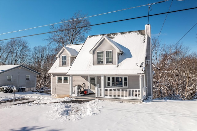 cape cod-style house featuring central AC and a porch