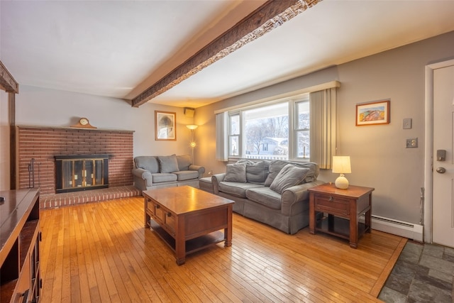 living room with a brick fireplace, light hardwood / wood-style flooring, beamed ceiling, and baseboard heating