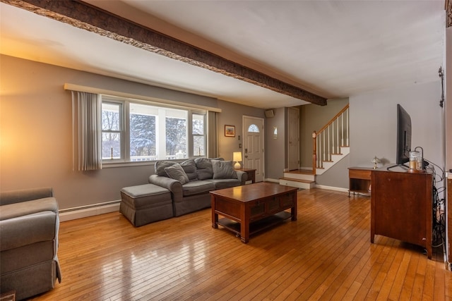 living room with beamed ceiling, a baseboard radiator, and light wood-type flooring