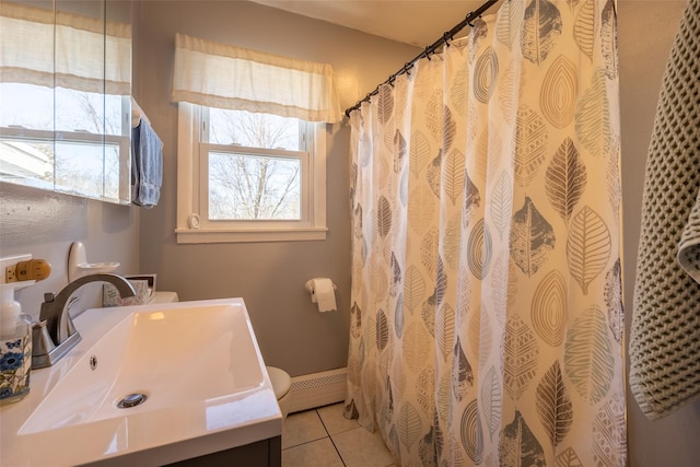 bathroom with vanity, a baseboard heating unit, a shower with curtain, and tile patterned floors