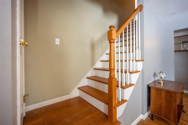 staircase with hardwood / wood-style flooring