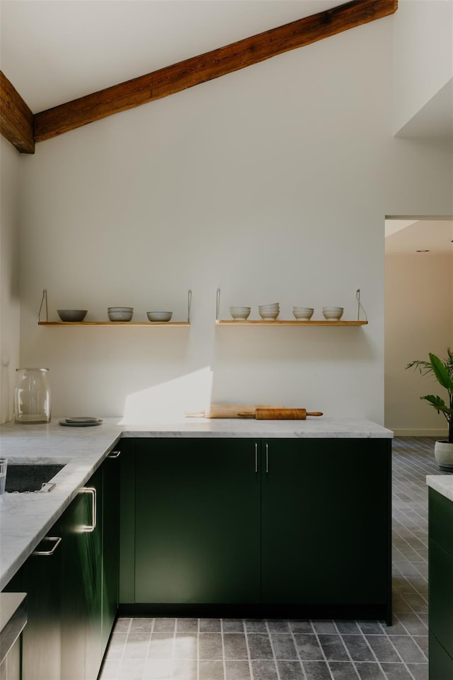 kitchen with beam ceiling and green cabinets