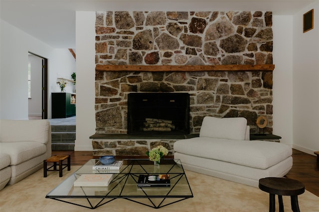 living room with hardwood / wood-style flooring and a fireplace