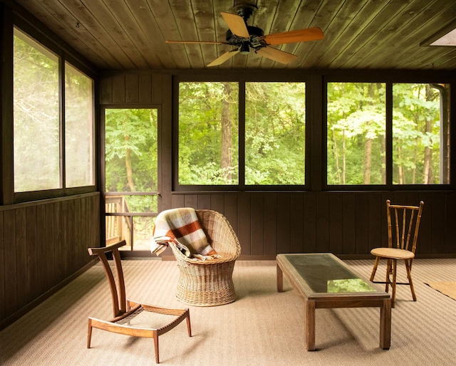 sunroom with wood ceiling and ceiling fan