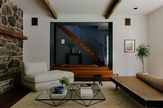 living room with beamed ceiling and a fireplace