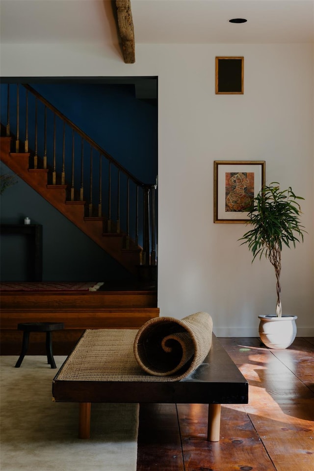 stairway featuring beamed ceiling