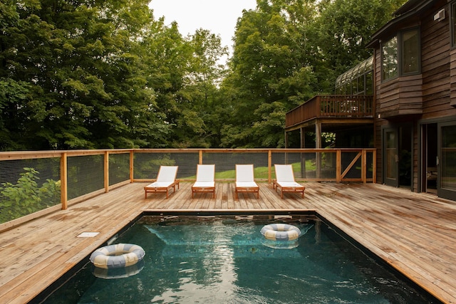 view of pool with a wooden deck