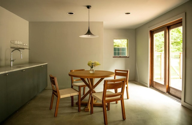 dining space with sink and concrete floors