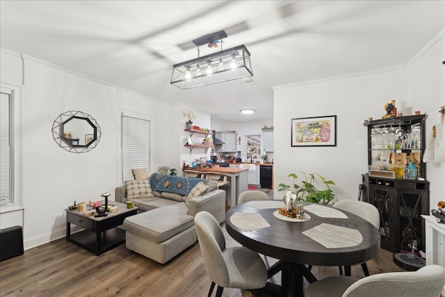 dining space with indoor bar, ornamental molding, and dark hardwood / wood-style floors