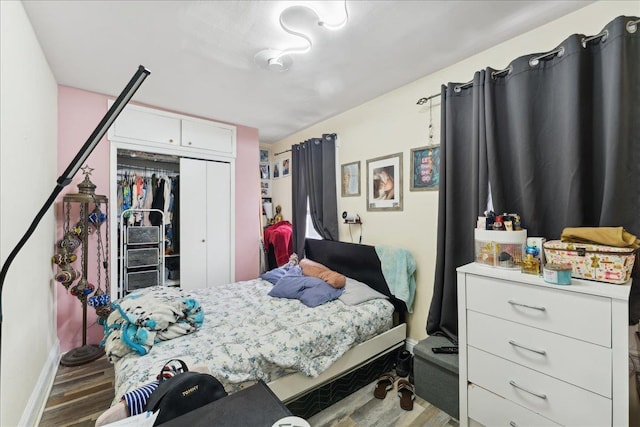 bedroom featuring dark hardwood / wood-style flooring and a closet