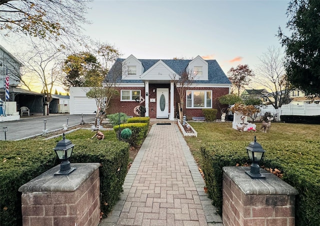 cape cod-style house with a lawn