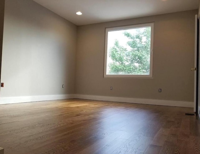 unfurnished room with dark hardwood / wood-style floors