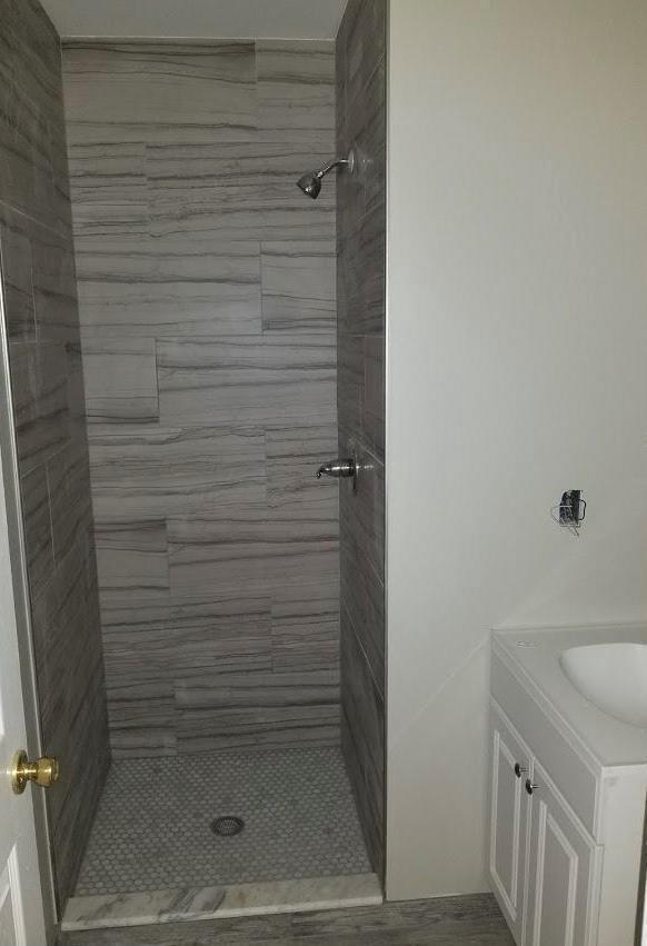 bathroom featuring vanity and a tile shower