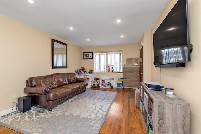 living room with radiator and hardwood / wood-style floors