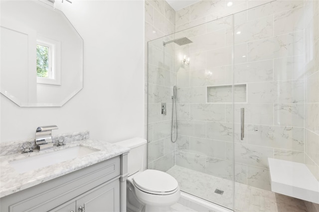 bathroom featuring walk in shower, vanity, and toilet