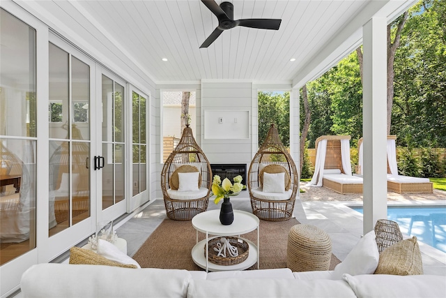 sunroom with wood ceiling, ceiling fan, and plenty of natural light