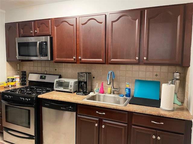 kitchen with sink, backsplash, and appliances with stainless steel finishes