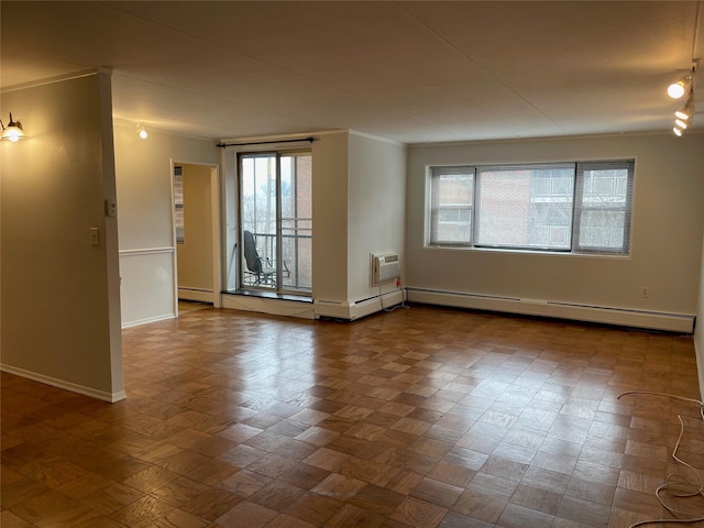 spare room featuring crown molding, a baseboard radiator, and an AC wall unit