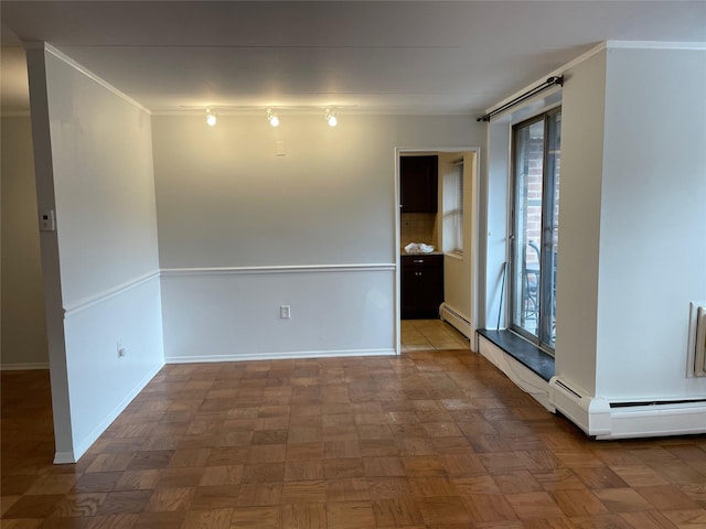 unfurnished room featuring a baseboard radiator, parquet flooring, and crown molding