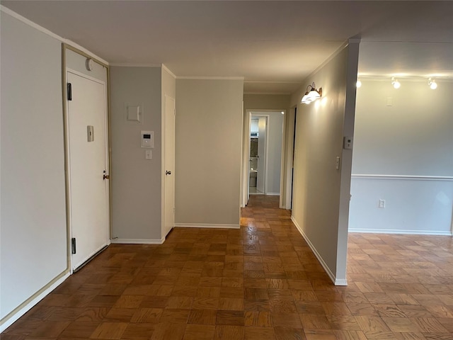 corridor with dark parquet flooring and ornamental molding