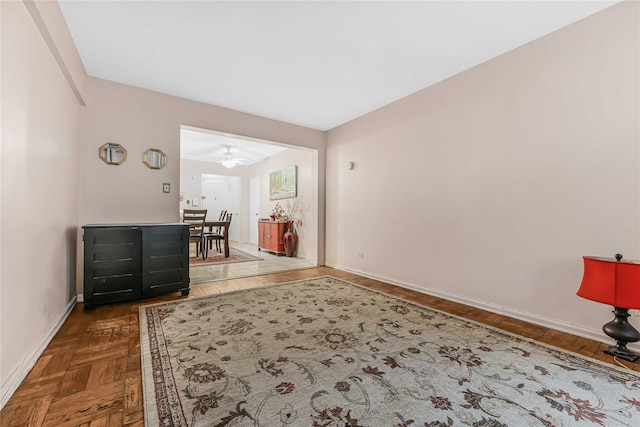 interior space featuring dark parquet flooring and ceiling fan