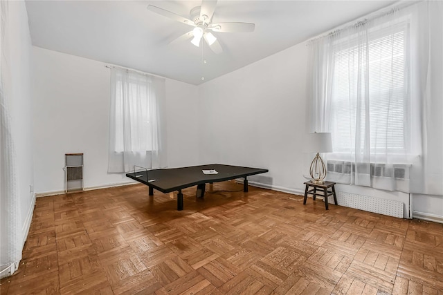 playroom with ceiling fan and parquet flooring