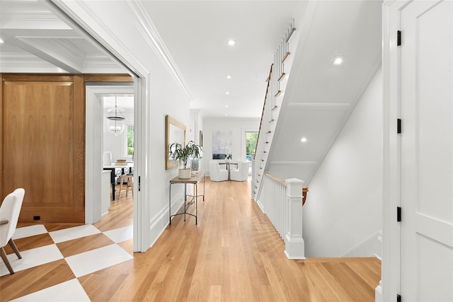 hallway featuring ornamental molding and light hardwood / wood-style flooring