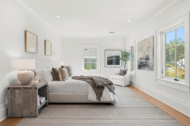 bedroom featuring crown molding and wood-type flooring