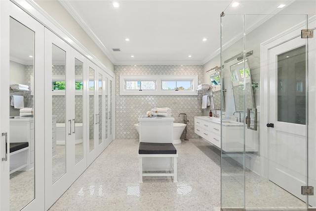 bathroom with ornamental molding, tile walls, vanity, and french doors