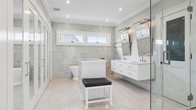 bathroom featuring tile walls, vanity, toilet, crown molding, and french doors