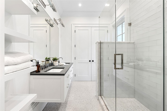 bathroom featuring vanity, crown molding, and a shower with shower door