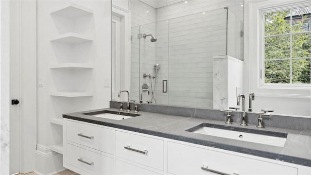 bathroom with vanity, a wealth of natural light, and a shower with shower door