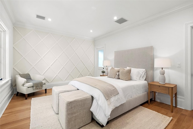 bedroom with crown molding and hardwood / wood-style floors