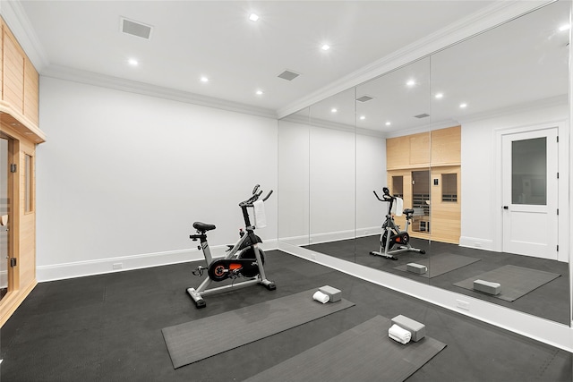 workout room featuring crown molding