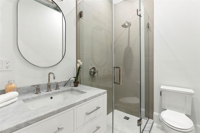 bathroom with vanity, an enclosed shower, and toilet