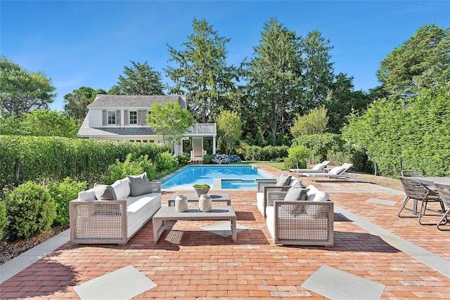 view of swimming pool with an outdoor living space and a patio