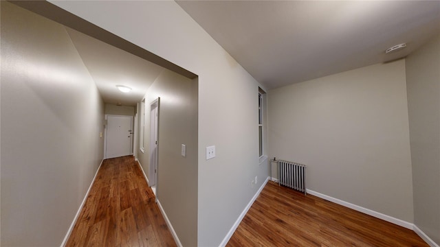 hall featuring hardwood / wood-style floors and radiator