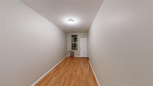 hall featuring light hardwood / wood-style flooring and radiator