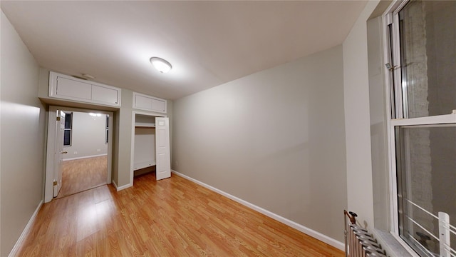 unfurnished bedroom featuring a closet and light hardwood / wood-style flooring