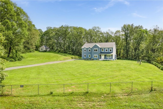 view of front facade featuring a rural view and a front lawn