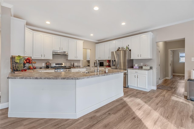 kitchen with ornamental molding, stainless steel appliances, and white cabinets