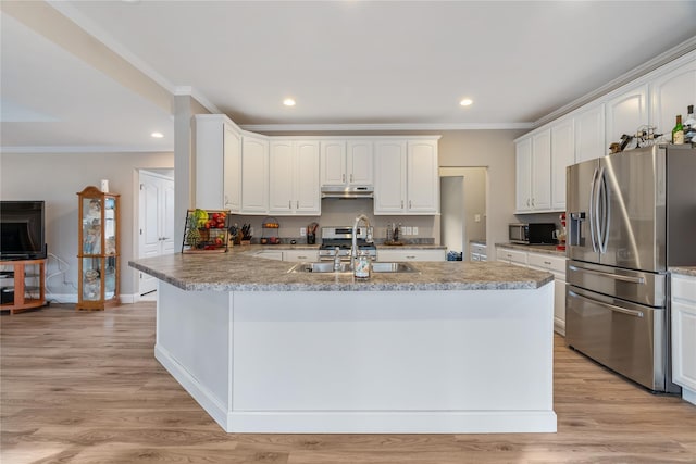 kitchen with sink, appliances with stainless steel finishes, ornamental molding, white cabinets, and light wood-type flooring