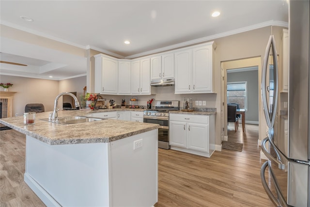 kitchen with sink, light wood-type flooring, kitchen peninsula, stainless steel appliances, and white cabinets